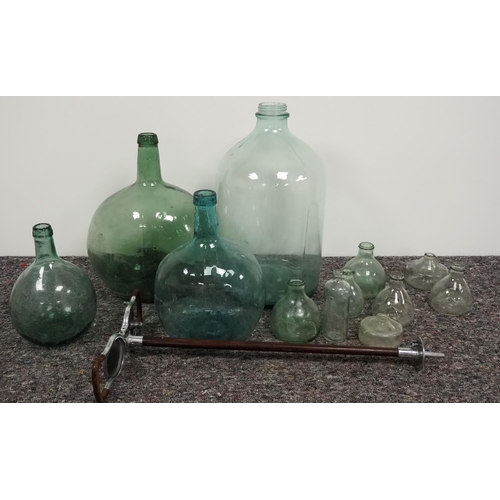 65 - Quantity of glass demijohns of Spanish origin, wasp traps and shooting stick