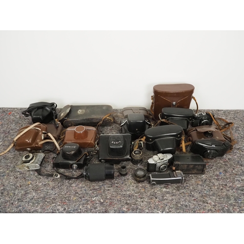 52 - Quantity of vintage cameras and binoculars to include Pentacon, Konica, Zenit, Swift, etc.