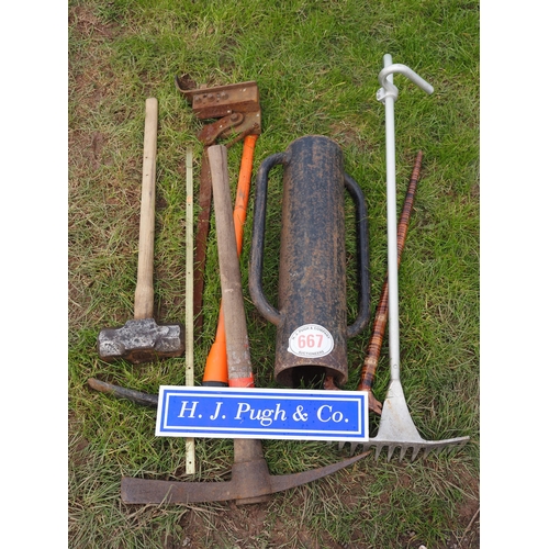 667 - Quantity of garden tools to include post knocker, pickaxe, etc.