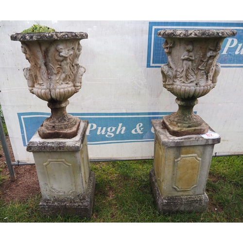 82 - Pair of urns on plinths approx. 5ft