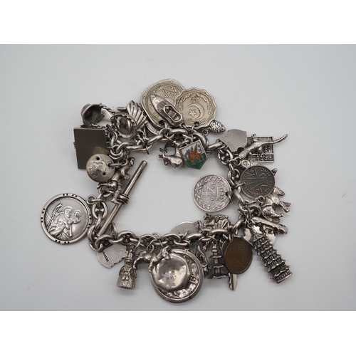 340 - Silver charm bracelet. Total weight approx. 132g