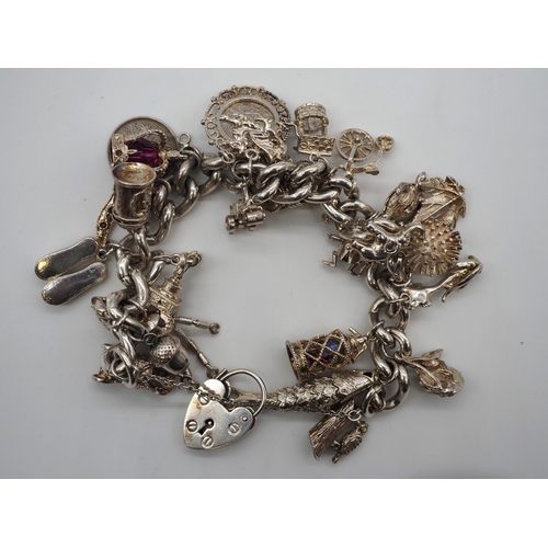 343 - Silver charm bracelet. Total weight approx. 141g