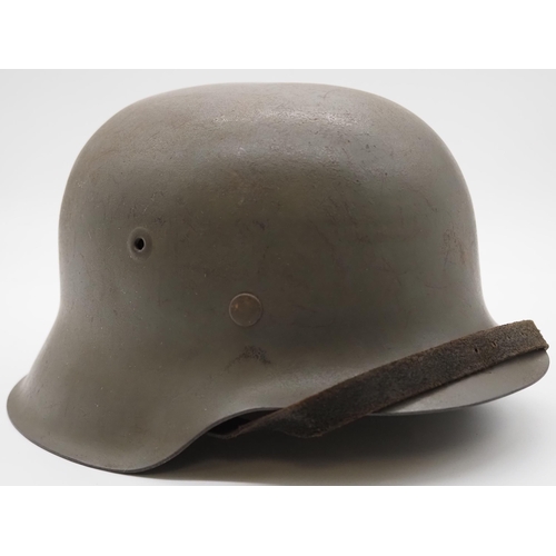 243 - WWII German M42 helmet complete with liner and chin strap