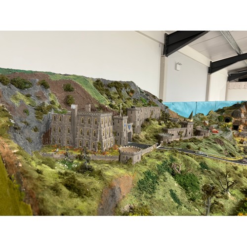 63A - OO Gauge scale model railway layout with detailed scenery including bridges, castles, stations, vehi... 