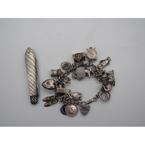 335A - Silver fruit knife and silver charm bracelet. Approx. 75g