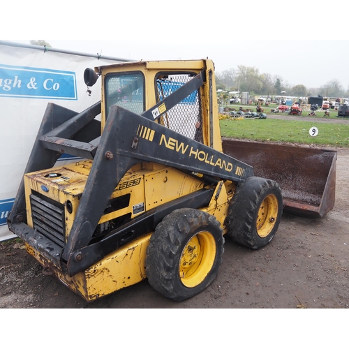 1592 - New Holland L553 skid steer loader and bucket