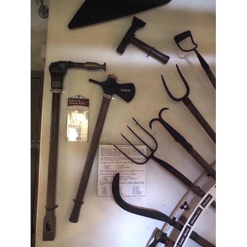 77 - Various early hand tools displayed on rack