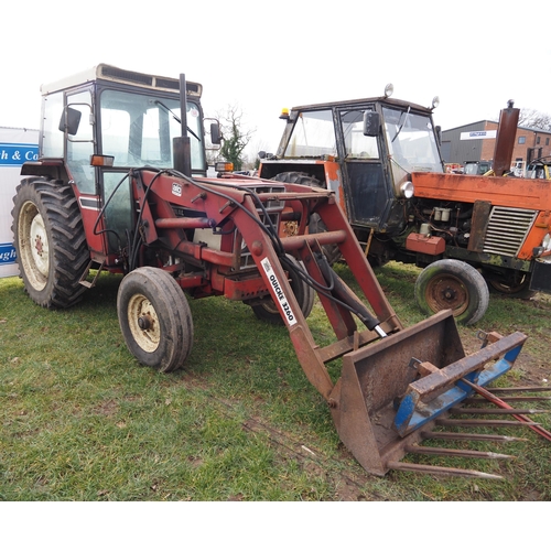 1648 - International 584 tractor. C/w Quicke 3260 loader, fork and bale spike. Showing 5677 hours. Reg. GMR... 