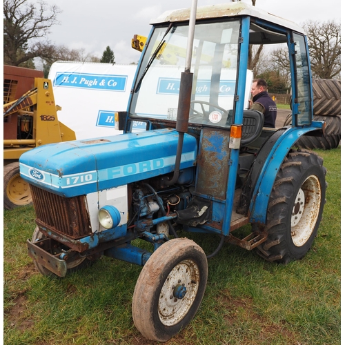 1731 - Ford 1710 compact tractor and cab frame. Runs and drives. Key in office