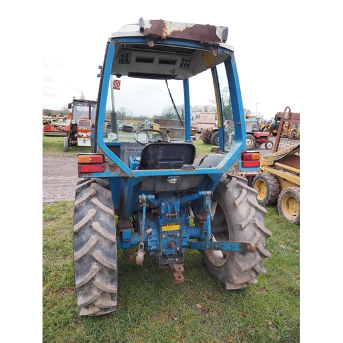 1731 - Ford 1710 compact tractor and cab frame. Runs and drives. Key in office