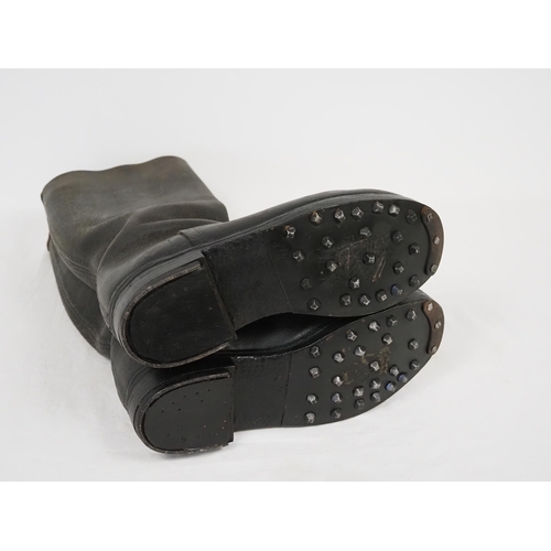 WWII long army boots with studs undergone restoration
