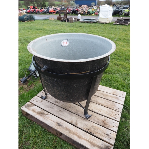 Large cast iron cauldron on stand