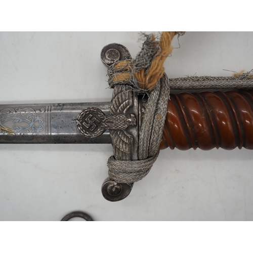 26 - WW2 German Officer's Dress Dagger. With an Red grip & wire wrap. Features detailed pommel & cross gu... 