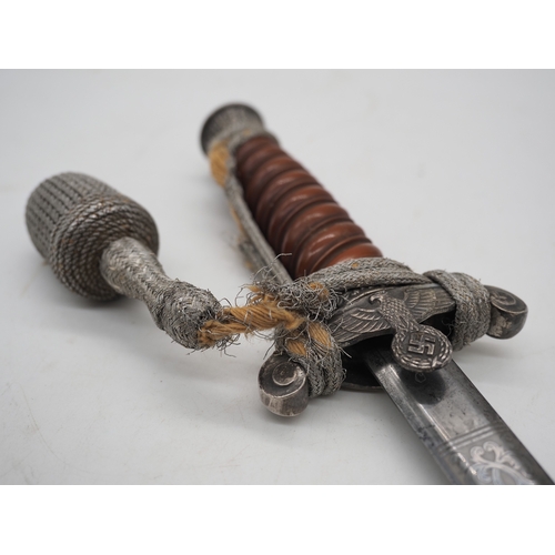 26 - WW2 German Officer's Dress Dagger. With an Red grip & wire wrap. Features detailed pommel & cross gu... 