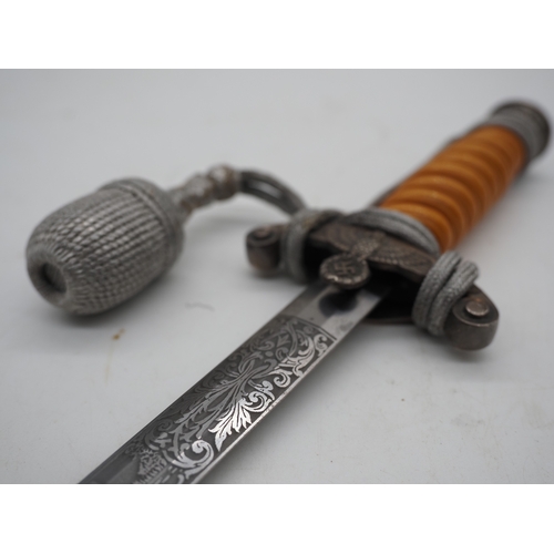 27 - WW2 German Officers Dress Dagger. With orange celluloid type grip. Detailed pommel with Eagle & Swas... 