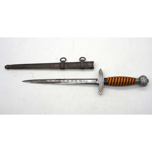 37 - WW2 German Officer's Dress Dagger. With an orange grip, featuring a detailed pommel with Swastika em... 