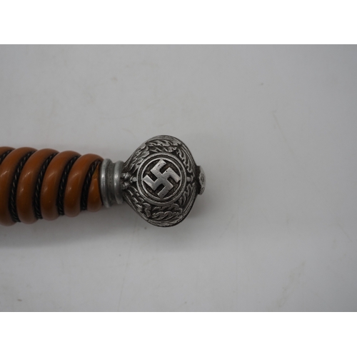 37 - WW2 German Officer's Dress Dagger. With an orange grip, featuring a detailed pommel with Swastika em... 
