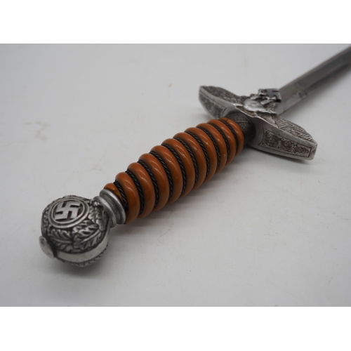 37 - WW2 German Officer's Dress Dagger. With an orange grip, featuring a detailed pommel with Swastika em... 