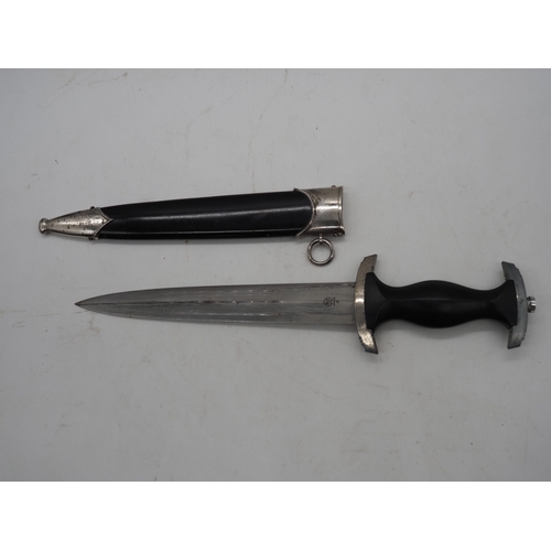 40 - WW2 German SS M33 Service Dagger. With black grip featuring eagle and Swastika and SS emblem, compet... 