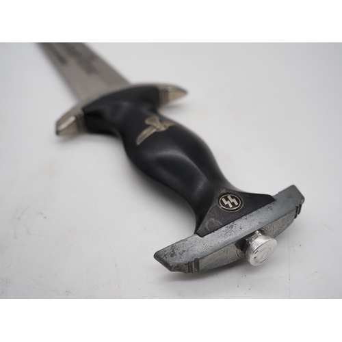 40 - WW2 German SS M33 Service Dagger. With black grip featuring eagle and Swastika and SS emblem, compet... 