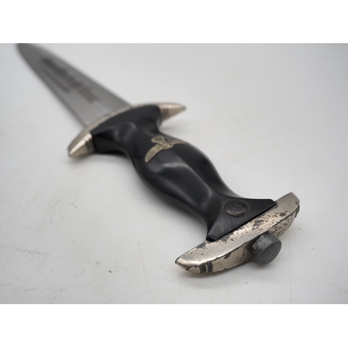 41 - WW2 German SS M33 Service Dagger. With black grip featuring eagle and Swastika and SS emblem, compet... 