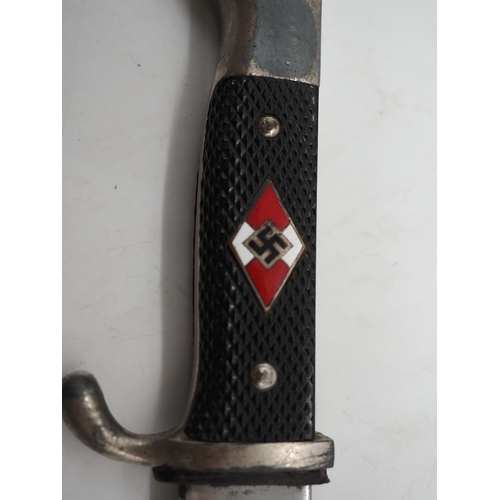45 - German Hitler Youth Knife. With a black chequered textured grip featuring the diamond Swastika emble... 