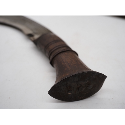 54 - Nepalese Ghurkha Knife. Carved wooden handle complete with carved wooden scabbard and single edged d... 