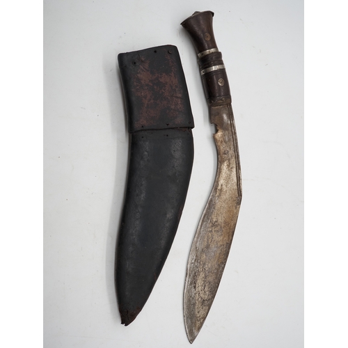 55 - Nepalese Ghurkha Knife. Ornate wooden and metal handle, complete with leather scabbard, single edged... 