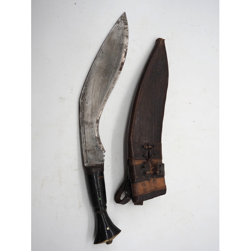 56 - Nepalese Ghurkha Knife. Polished black wooden handle with brass pommel and complete with leather sca... 