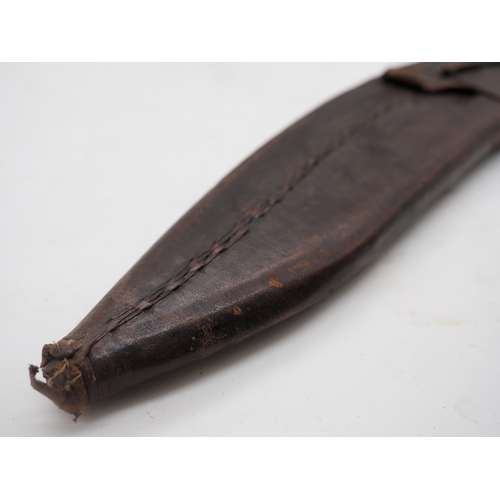 56 - Nepalese Ghurkha Knife. Polished black wooden handle with brass pommel and complete with leather sca... 