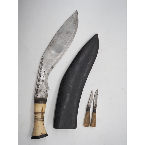 57 - Ghurkha Knife With a Bone Handle Grip. Complete with a leather scabbard with a single edged decorati... 