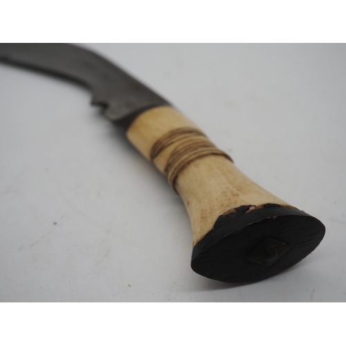 57 - Ghurkha Knife With a Bone Handle Grip. Complete with a leather scabbard with a single edged decorati... 