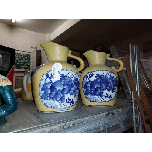 613 - 2 Blue And Yellow Patterned Jugs