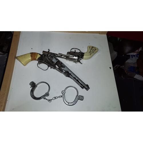 113 - Streamline Toy Gun, Handle Taped Plus Lonestar Buckaroo Toy Gun With Lonestar Handcuffs