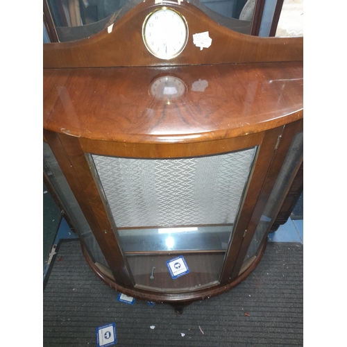 84 - Bow Fronted Display Cabinet With Smiths Clock To Upstand Door Needs Repairing