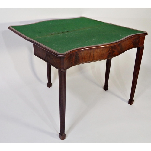 512 - George III crossbanded flame mahogany serpentine games table, with baize lined interior and reeded l... 