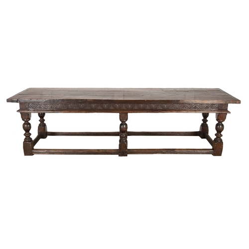 552 - Impressive 17th century style refectory table, thick oak top over a carved floral frieze and six bal... 