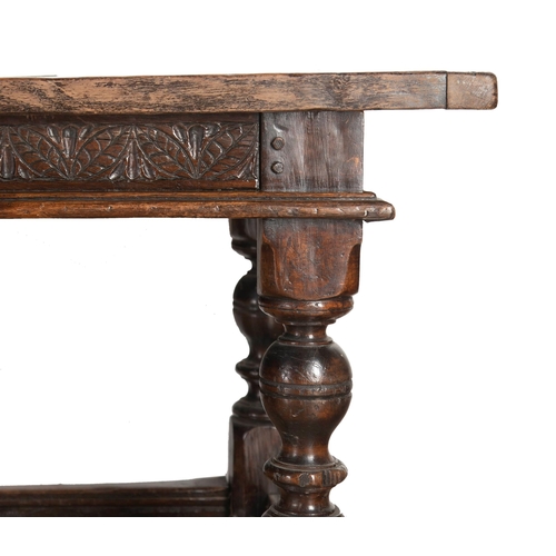 552 - Impressive 17th century style refectory table, thick oak top over a carved floral frieze and six bal... 