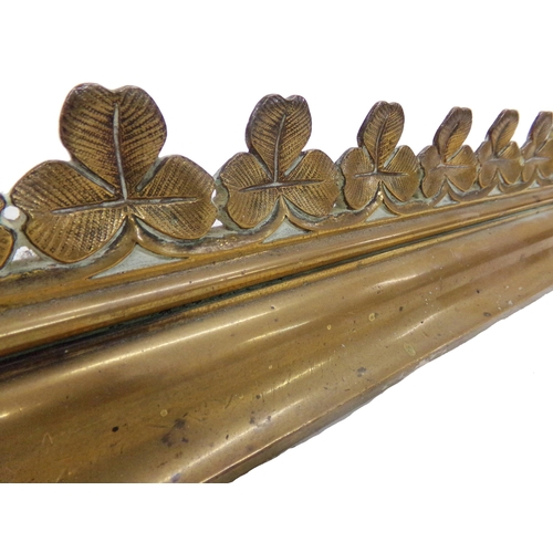 558 - Owen Jones (1809-1874) - arts and crafts brass fire fender, with repeating cast shamrock design, 120... 