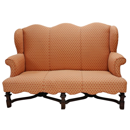 568 - Antique Queen Anne style camel back sofa, with geometric salmon upholstery, wavy apron and carved fr... 