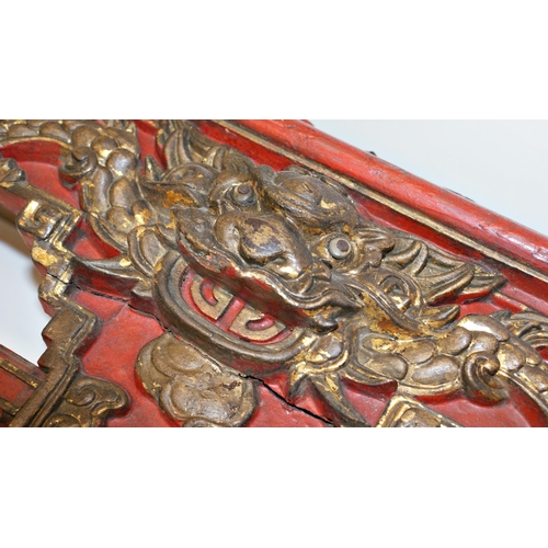 105 - Antique Chinese carved and red lacquered bed panel or pelmet, with gilt highlights, carved with bird... 