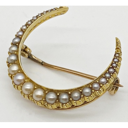 312 - A yellow metal brooch in the form of a crescent set with graduated seed pearls together with a bar b... 