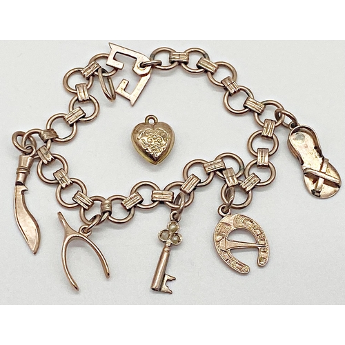 326 - 9ct gold charm bracelet with seven charms (one loose) 17 cm long approx. Weight 14.61g approx.