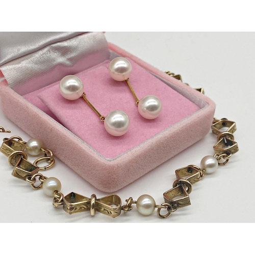 329 - Pair of 18ct gold and cultured pearl drop earrings. Posts and butterfly's stamped 18ct 750. 2.5 cm l... 