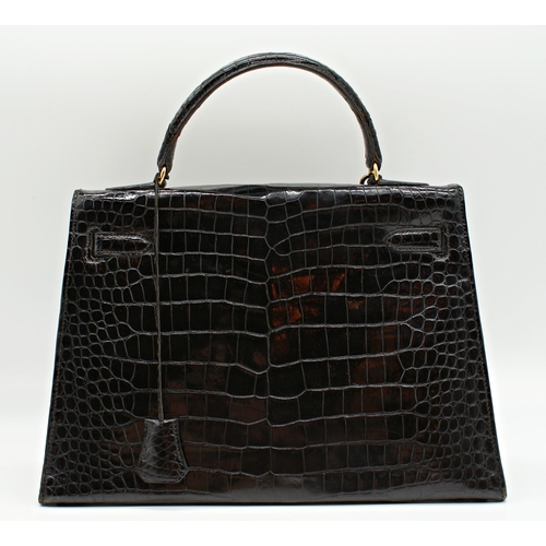 499 - Rare 1959 Hermes of Paris crocodile leather Kelly bag, with padlock, key and suede dust cover, 23 x ... 