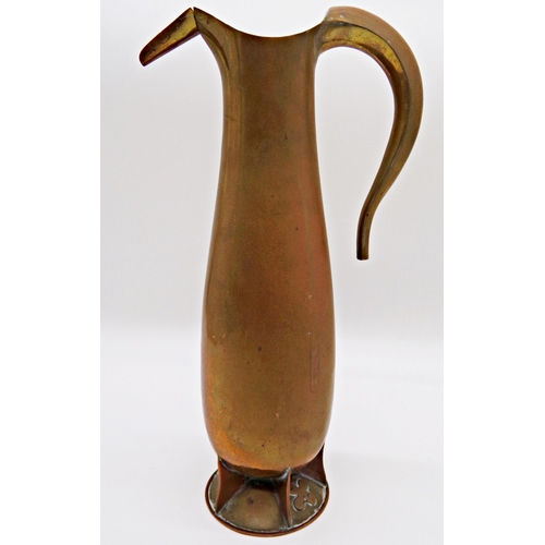 127 - Arts and Crafts copper jug of tall organic baluster form, with segmented base and unusual flower hea... 