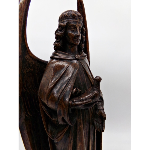 143 - Good quality antique Flemish oak carving of an angel holding a dove, 51cm high