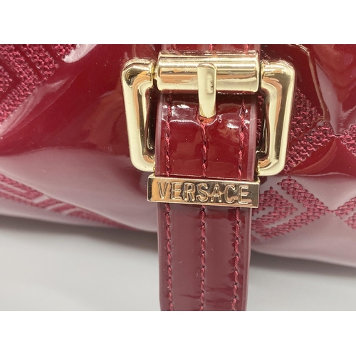 496 - Versace 'Snap Out Of It' bag, in deep red, in as new condition, original dust bag and guarantee card... 