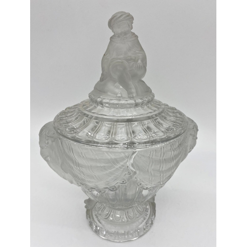 66 - Good quality Baccarat pressed jar candy jar and cover, the lid mounted by a seated Eastern figure, w... 