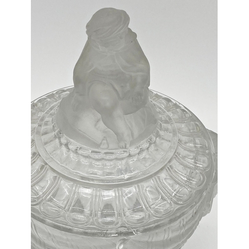 66 - Good quality Baccarat pressed jar candy jar and cover, the lid mounted by a seated Eastern figure, w... 